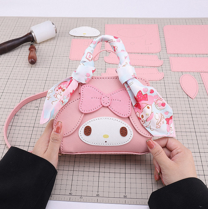 Handmade pink leather handbag DIY kit showing pre-cut leather pieces during assembly